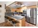 Modern kitchen featuring stainless steel appliances, bar seating, and neutral toned cabinetry at 7740 E Heatherbrae Ave # 5, Scottsdale, AZ 85251
