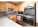 This kitchen features wooden cabinets, stainless appliances, and mosaic backsplash at 7740 E Heatherbrae Ave # 5, Scottsdale, AZ 85251