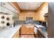 Bright kitchen featuring wooden cabinets, sleek countertops, and stainless steel appliances at 7740 E Heatherbrae Ave # 5, Scottsdale, AZ 85251