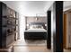 This main bedroom features brick accent wall, shelving, and a queen-sized bed at 7740 E Heatherbrae Ave # 5, Scottsdale, AZ 85251