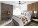 Cozy main bedroom with ceiling fan, brick accent wall, and southwestern decor at 7740 E Heatherbrae Ave # 5, Scottsdale, AZ 85251