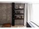 Unique shelving against brick wall offers space for decorative items in this main bedroom at 7740 E Heatherbrae Ave # 5, Scottsdale, AZ 85251