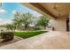 Covered patio with view of a backyard featuring trees, grass, and a swimming pool at 7829 E Softwind Dr, Scottsdale, AZ 85255