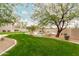 Lush backyard with a well-manicured lawn, inviting pool, and mature trees at 7829 E Softwind Dr, Scottsdale, AZ 85255