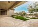 Spacious backyard with covered patio, green lawn, mature trees, and a refreshing pool at 7829 E Softwind Dr, Scottsdale, AZ 85255