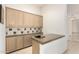 A convenient bar area featuring cabinetry, countertops, and a sink for effortless entertaining at 7829 E Softwind Dr, Scottsdale, AZ 85255