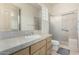 A bright bathroom includes a vanity with solid surface countertop and sliding glass door shower at 7829 E Softwind Dr, Scottsdale, AZ 85255