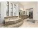 A luxurious bathroom features a large soaking tub, dual vanity, and walk-in closet at 7829 E Softwind Dr, Scottsdale, AZ 85255