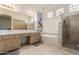 Bathroom with dual sinks, a bathtub, and a glass-enclosed shower offers style and convenience at 7829 E Softwind Dr, Scottsdale, AZ 85255