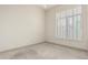 Cozy bedroom offers natural light from shuttered window with neutral carpet at 7829 E Softwind Dr, Scottsdale, AZ 85255