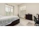 Bright bedroom featuring a queen bed, shuttered windows, and acoustic guitars at 7829 E Softwind Dr, Scottsdale, AZ 85255