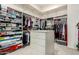 Walk-in closet with built-in shelving, drawers, and island offers ample storage space at 7829 E Softwind Dr, Scottsdale, AZ 85255