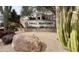 Vista Monterey community sign with desert landscaping featuring a rock and assorted cactus at 7829 E Softwind Dr, Scottsdale, AZ 85255