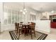 Bright dining area with shuttered windows and an elegant chandelier, perfect for Gathering gatherings at 7829 E Softwind Dr, Scottsdale, AZ 85255