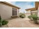 Exterior close-up reveals xeriscape landscaping, a private courtyard entry, and custom windows at 7829 E Softwind Dr, Scottsdale, AZ 85255