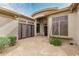 Exterior features private courtyard entry, a beautiful custom door, and xeriscape landscape design at 7829 E Softwind Dr, Scottsdale, AZ 85255