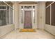 Front shot featuring an ornate, custom front door with sidelights, transom window, and welcome mat at 7829 E Softwind Dr, Scottsdale, AZ 85255
