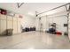Organized garage with storage cabinets, ladder and room for multiple cars at 7829 E Softwind Dr, Scottsdale, AZ 85255