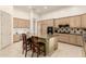 Bright kitchen featuring a central island with seating, custom cabinetry, and a tiled backsplash at 7829 E Softwind Dr, Scottsdale, AZ 85255