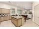 Open-concept kitchen with a large center island, adjacent dining area, and bright, shuttered windows at 7829 E Softwind Dr, Scottsdale, AZ 85255