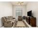A comfortable living room with a sofa, recliner, and media center, perfect for relaxation at 7829 E Softwind Dr, Scottsdale, AZ 85255