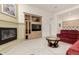 Spacious living room featuring a modern fireplace, custom built-ins, and seamless access to other living spaces at 7829 E Softwind Dr, Scottsdale, AZ 85255