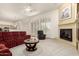 Inviting living room with a cozy fireplace, comfortable seating, and bright, natural lighting at 7829 E Softwind Dr, Scottsdale, AZ 85255