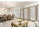 An open-concept living space with dining and decorative windows with glass doors at 7829 E Softwind Dr, Scottsdale, AZ 85255