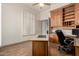 An efficient home office with built-in storage and a window for natural light at 7829 E Softwind Dr, Scottsdale, AZ 85255