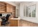 An organized home office with custom shelving and a functional layout at 7829 E Softwind Dr, Scottsdale, AZ 85255
