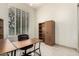 Office space has a large desk, an ergonomic chair, and a floor-to-ceiling bookshelf at 7829 E Softwind Dr, Scottsdale, AZ 85255
