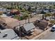 Aerial view of a small home with a fenced yard, parking lot and surrounding neighborhood at 909 N 10Th St, Phoenix, AZ 85006