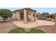 Landscaped backyard featuring a covered patio and a refreshing pool with a charming rock waterfall feature at 10762 W Cimarron Dr, Peoria, AZ 85373