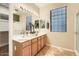 Bright bathroom boasts a double sink vanity, large mirror, and separate shower at 10762 W Cimarron Dr, Peoria, AZ 85373