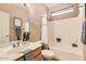 Cozy bathroom with a shower/tub combo and vanity with sink at 10762 W Cimarron Dr, Peoria, AZ 85373