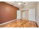 Bedroom with hardwood floors, neutral walls, and a view to another room at 10762 W Cimarron Dr, Peoria, AZ 85373