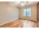 Neutral bedroom with a ceiling fan, hardwood floors, and a large window at 10762 W Cimarron Dr, Peoria, AZ 85373