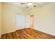 Comfortable bedroom featuring a ceiling fan, closet, and hardwood floors at 10762 W Cimarron Dr, Peoria, AZ 85373