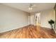 Spacious bedroom with hardwood floors, neutral paint, and a ceiling fan for a relaxing atmosphere at 10762 W Cimarron Dr, Peoria, AZ 85373