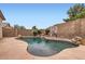 A beautiful backyard pool featuring a waterfall, basketball hoop, and ample space for relaxation and recreation at 10762 W Cimarron Dr, Peoria, AZ 85373