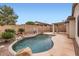 Backyard pool with a rock waterfall feature, basketball hoop and a large patio area for entertaining at 10762 W Cimarron Dr, Peoria, AZ 85373