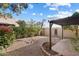 Landscaped backyard featuring a covered patio, privacy fence, and desert landscaping at 10815 N 117Th Pl, Scottsdale, AZ 85259