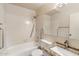 Bathroom featuring white-tiled walls and accessible grab bars at 10815 N 117Th Pl, Scottsdale, AZ 85259