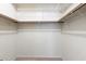 Walk-in closet with wooden rods and wire shelving at 10815 N 117Th Pl, Scottsdale, AZ 85259