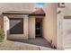 Close up view of a home's entrance, showing the front door, address numbers, and adjacent desert landscaping at 10815 N 117Th Pl, Scottsdale, AZ 85259