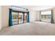 Bright living room featuring neutral carpet and sliding doors to the backyard at 10815 N 117Th Pl, Scottsdale, AZ 85259