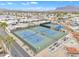 An overhead view shows community tennis courts, desert landscaping and parked cars at 1152 S Sioux Dr, Apache Junction, AZ 85119