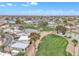 An aerial view featuring a pond and golf course surrounded by mobile homes and desert landscaping at 1152 S Sioux Dr, Apache Junction, AZ 85119