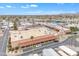 Aerial view of a community clubhouse, parking, and outdoor dining with a pool area and desert landscaping at 1152 S Sioux Dr, Apache Junction, AZ 85119