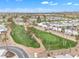 An aerial view showcases a community golf course, desert landscaping, and residential homes at 1152 S Sioux Dr, Apache Junction, AZ 85119